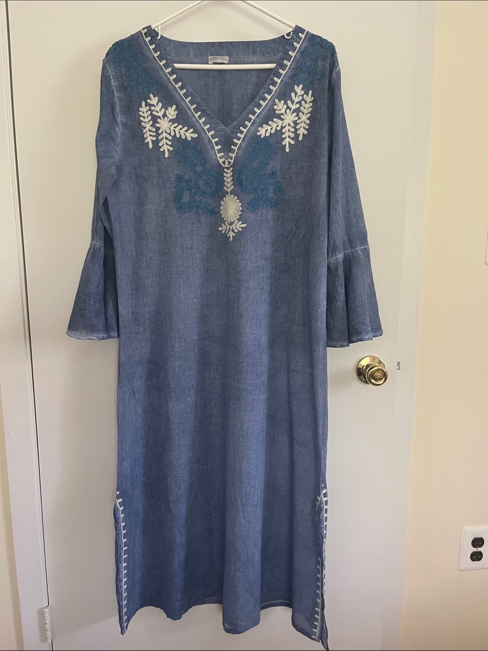 The blue V-neck tunic with white floral embroidery, Debbie Katz South Beach.